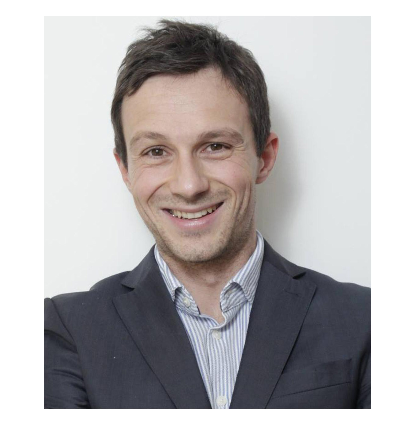 Dr Filippo Fontanelli has brown eyes and short brown hair. He smiles into the camera wearing a striped shirt and grey suit jacket. 