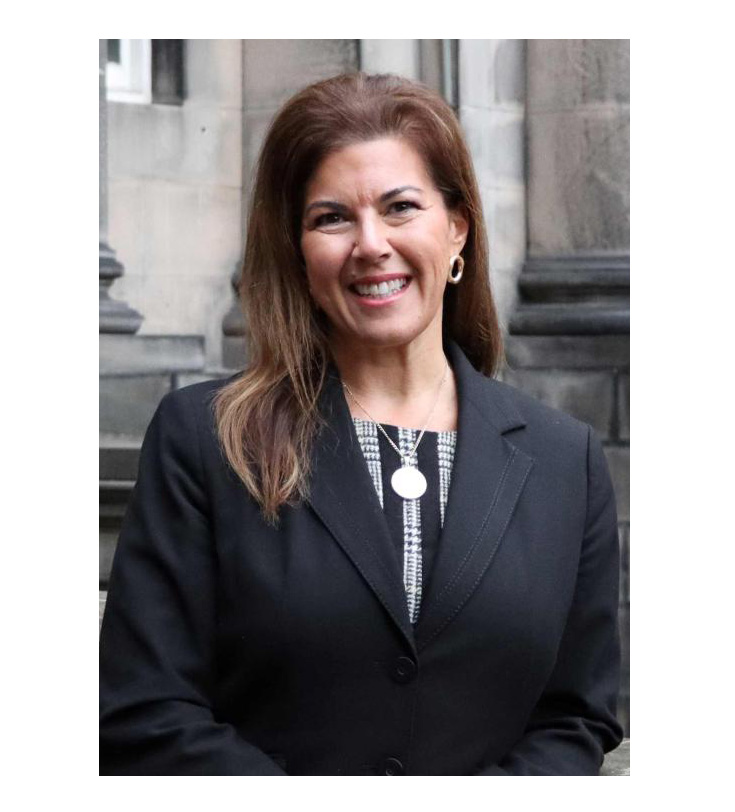 Professor Veronica Ruiz smiled into the camera wearing a smart suit jacket.