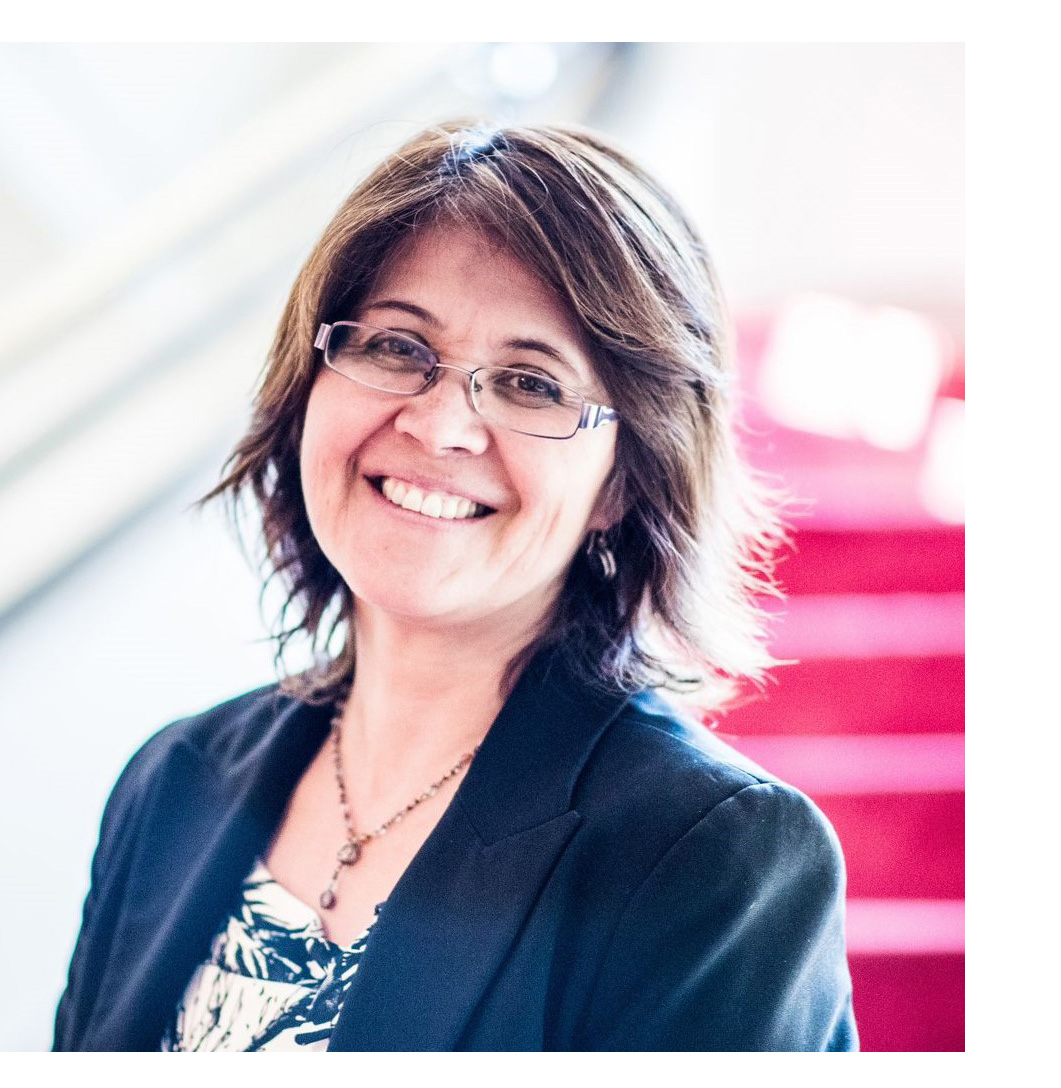 A head shot of the speaker Ximena Fuentes with short brown hair, glasses. She smiles kindly into the camera. 