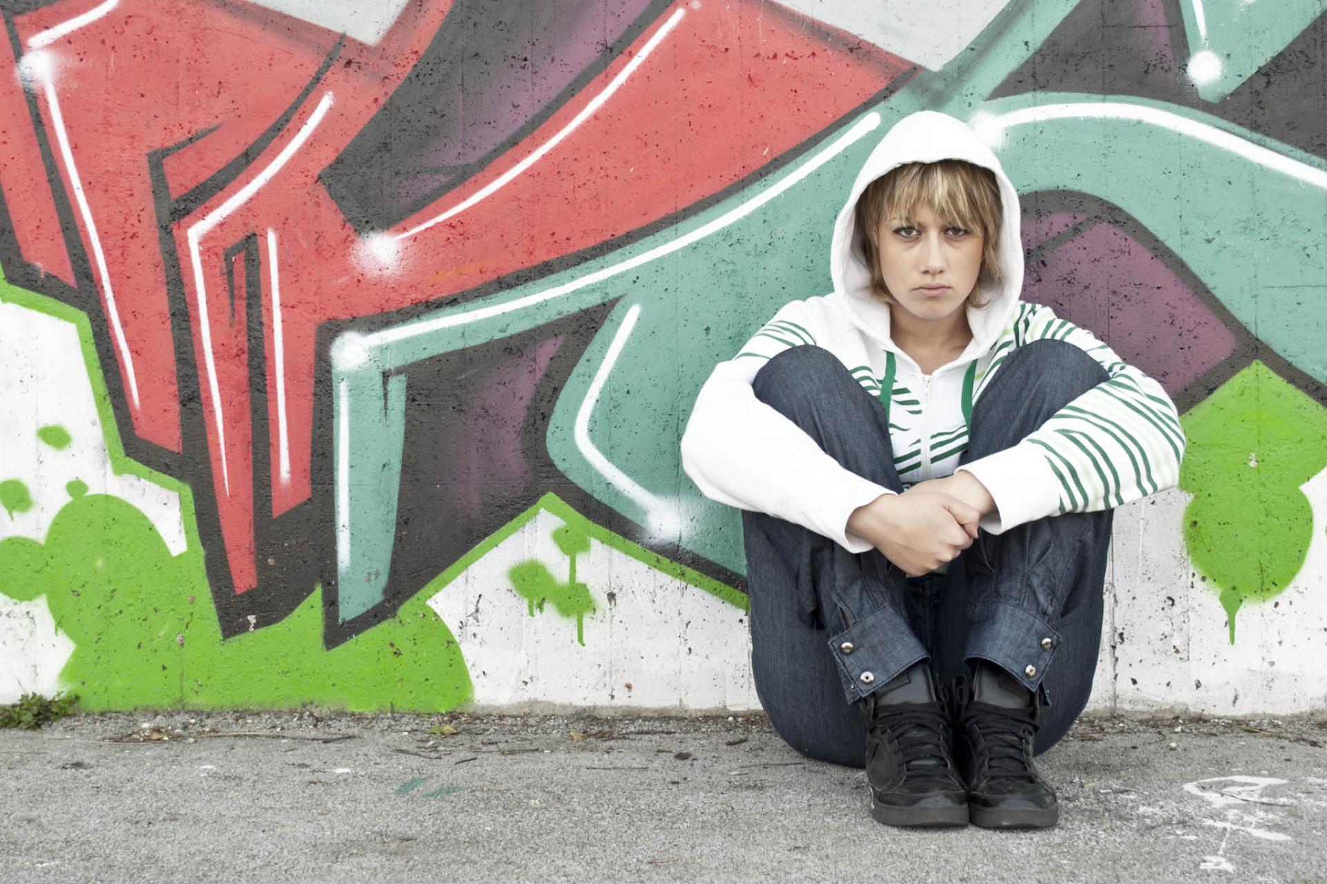 Girl in front of graffiti