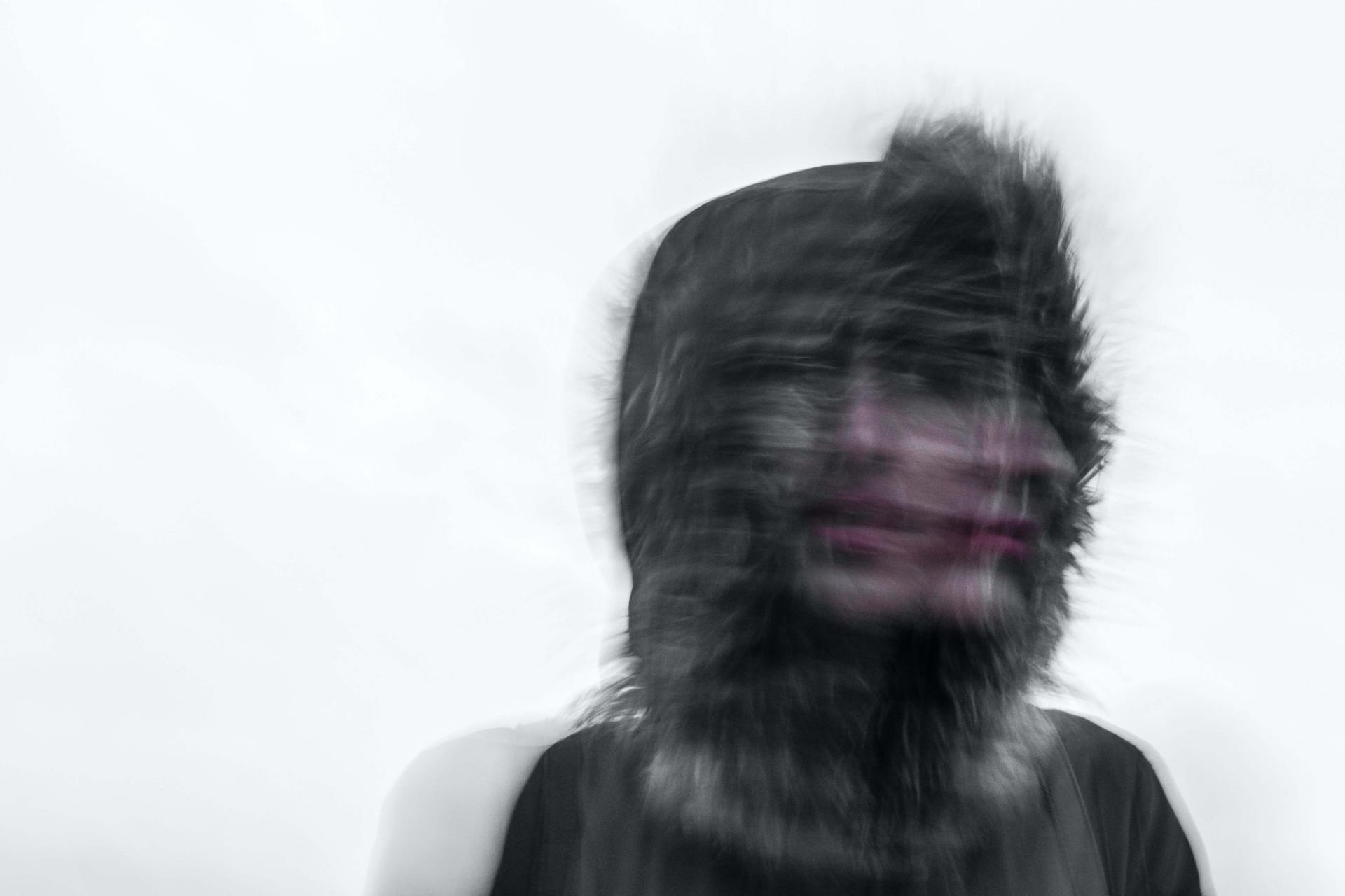 Blurred person in hooded jacket
