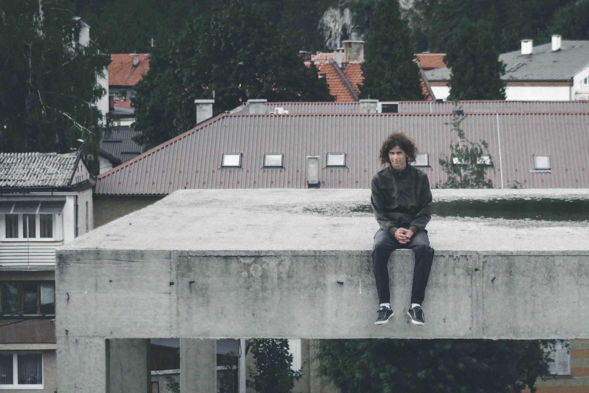 Man sittong on concrete roof