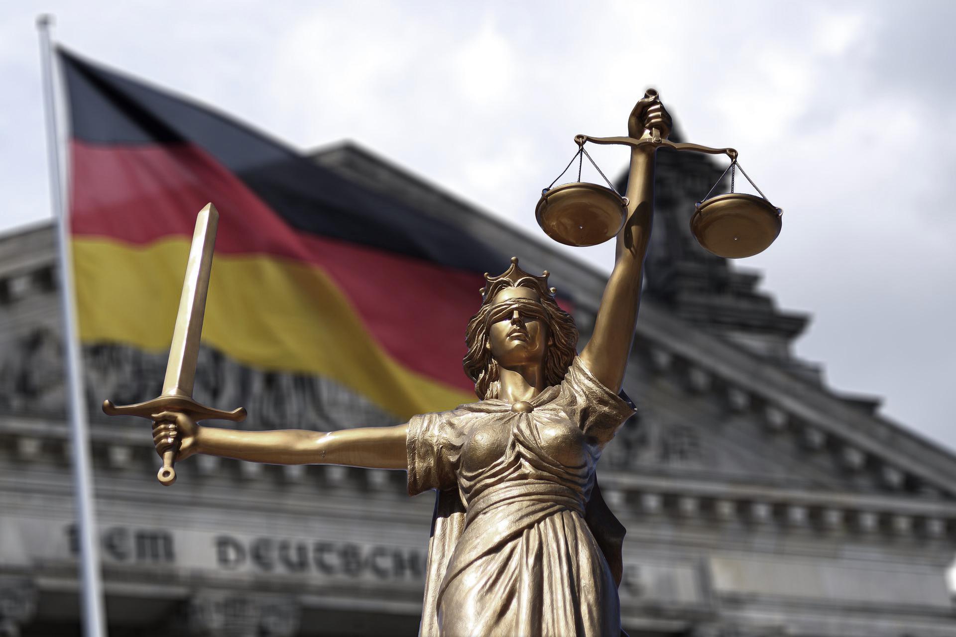 Lady Justice in front of German Flag & building