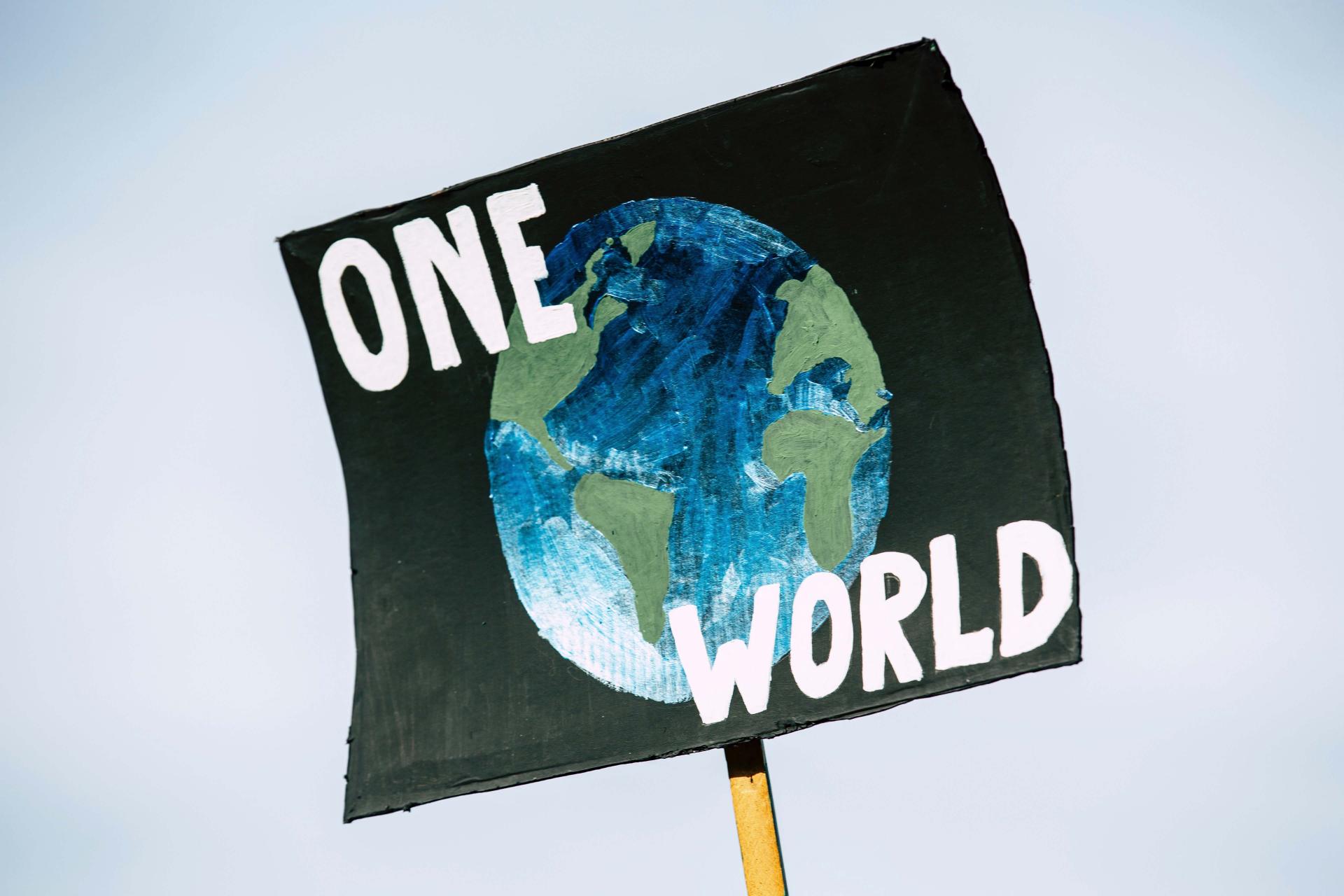 poster of the world with 'one world' text