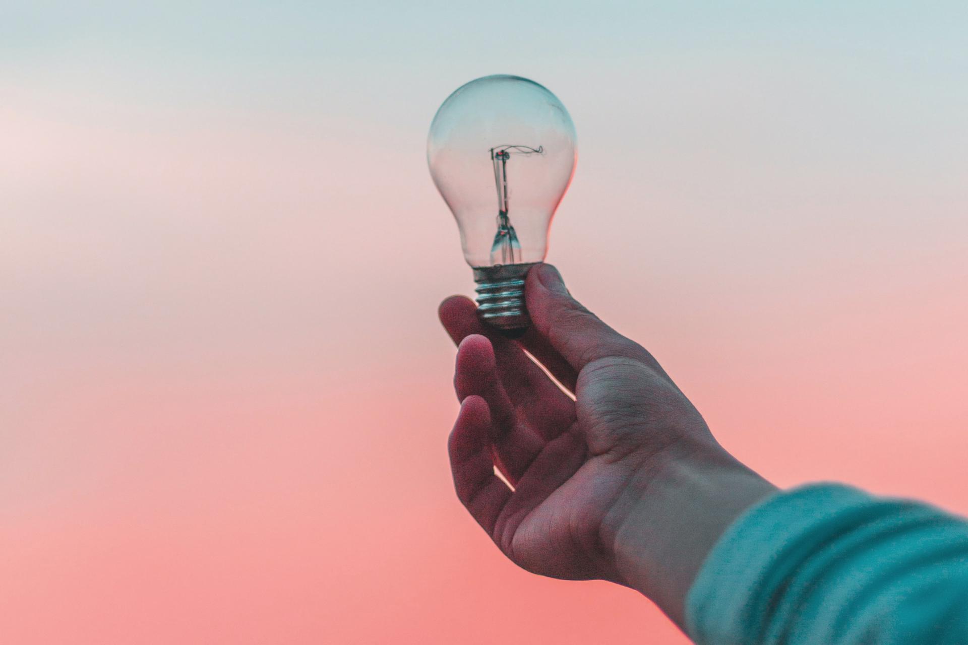 hand holding lightbulb