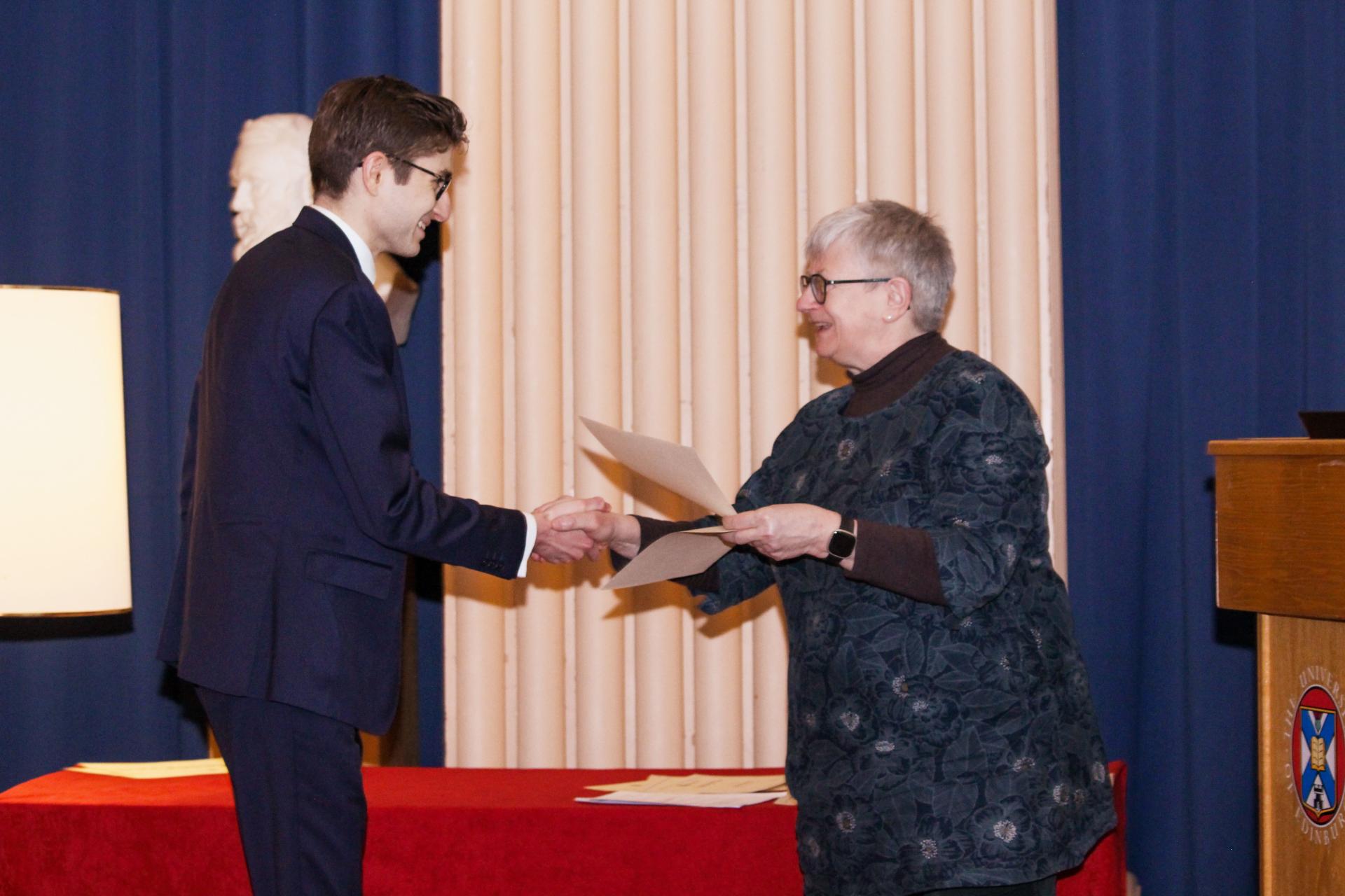 Nicholas Oprescu-Havrillis accepting their award from Jo Shaw, Head of the Law School