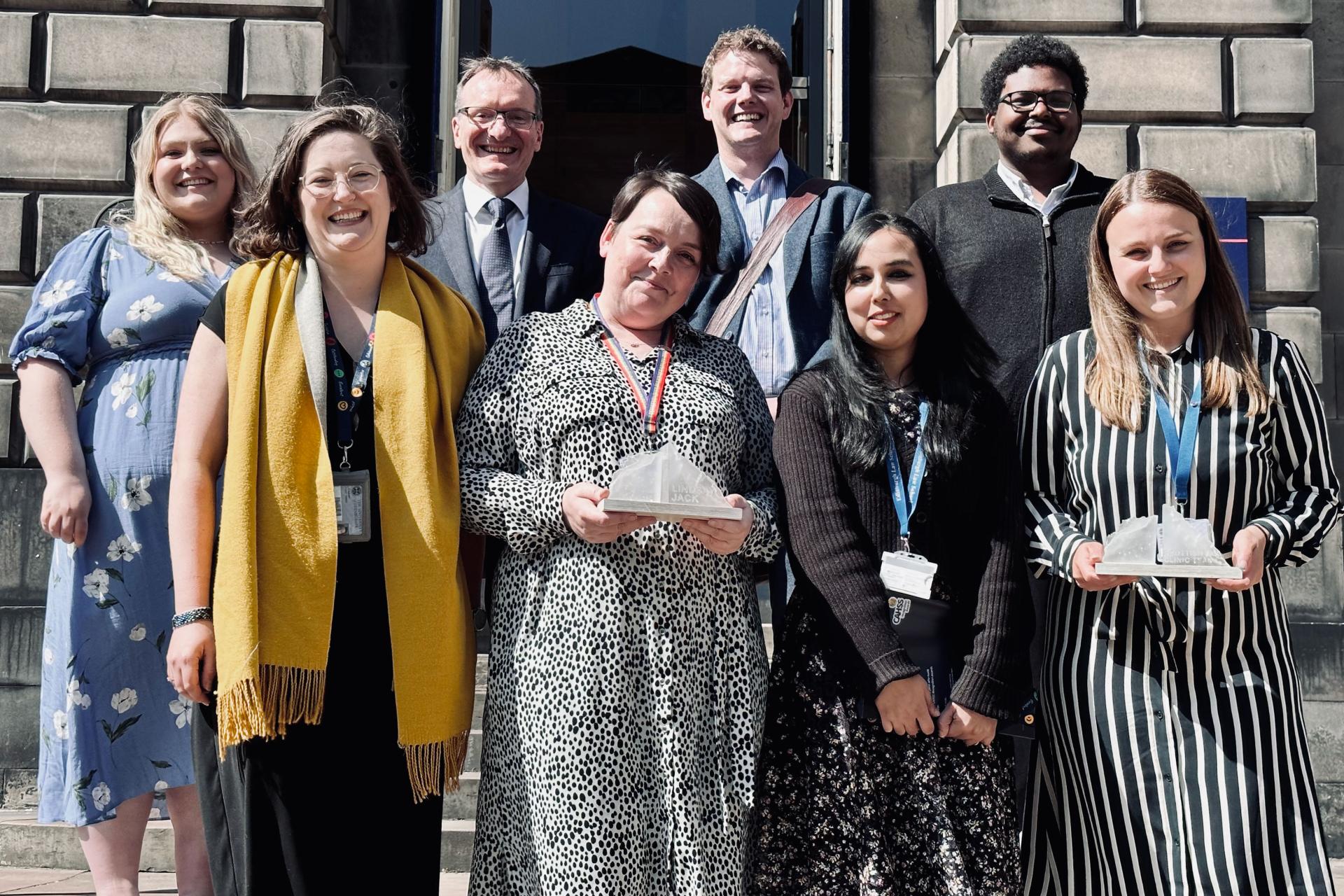 Scottish Tax Clinic volunteers, Lindsay Jack and Samera Yasin standing on the steps at the law school smiling