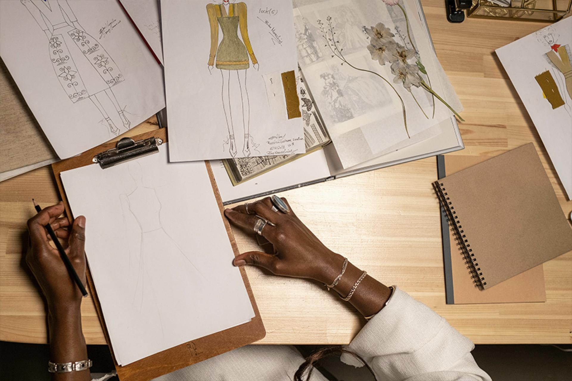 A person sketching fashion designs