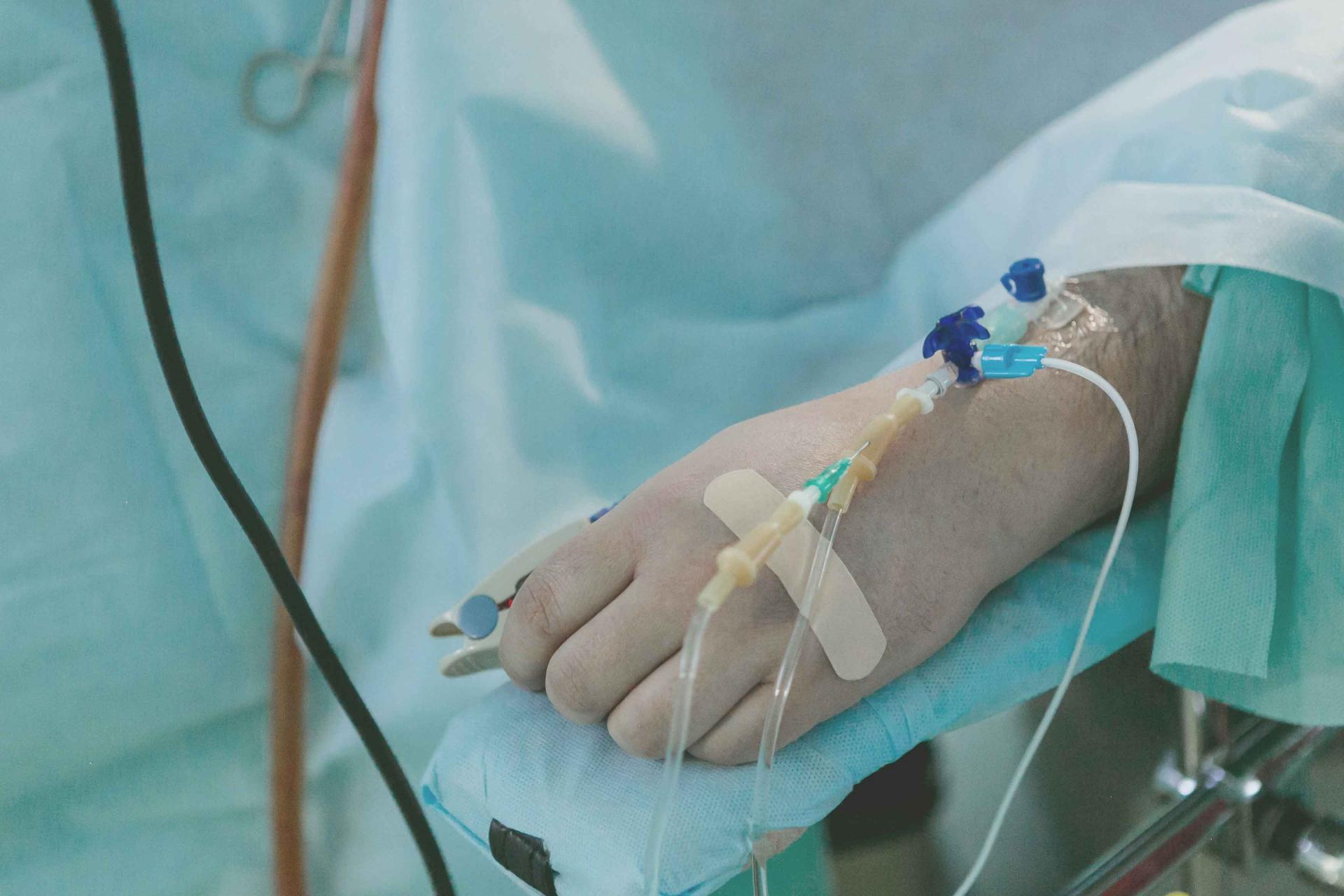 a hand with a wires and a drip attatched