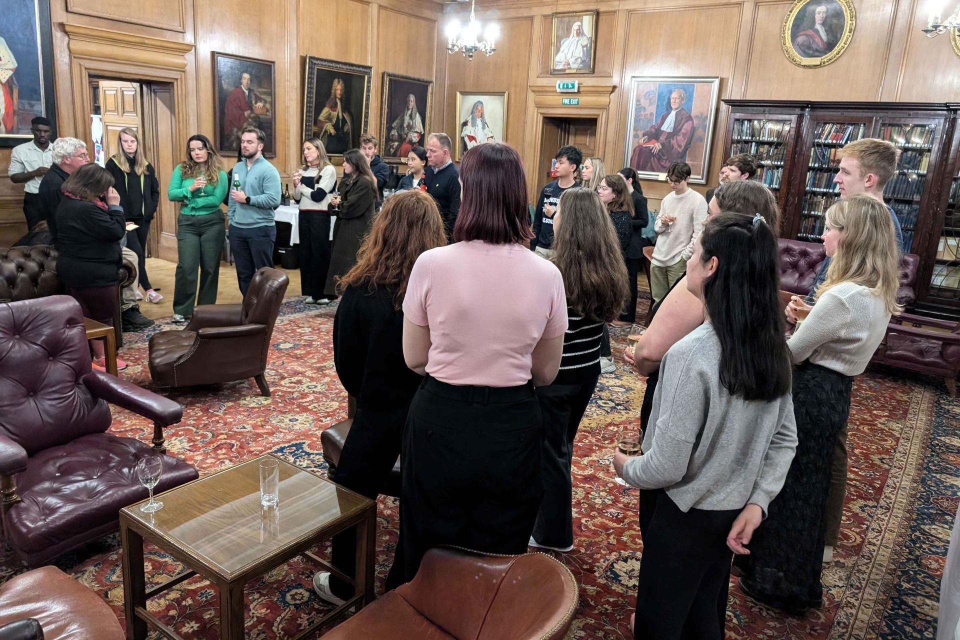 a group of people standing in the library