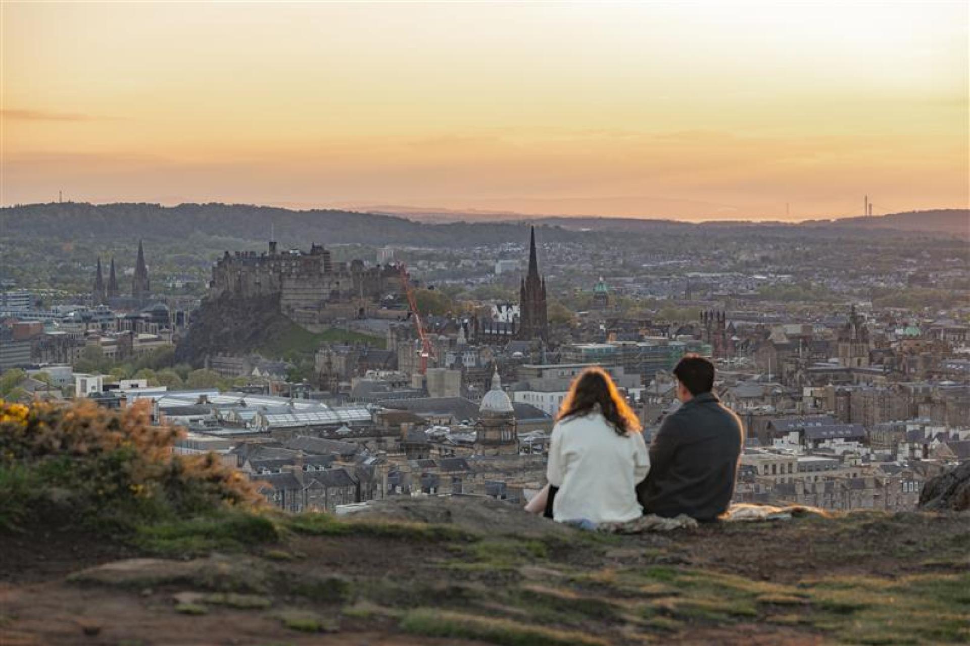 Two students overlooking Edinburgh skyline