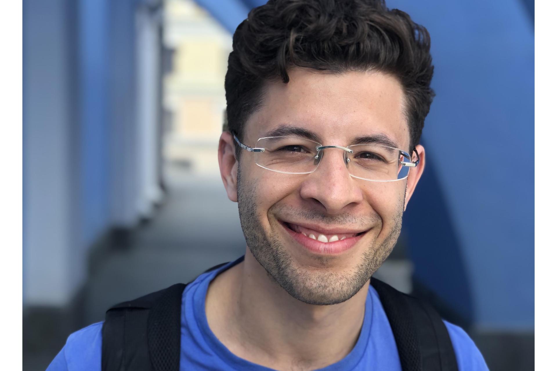 Man wearing glasses and smiling to the camera