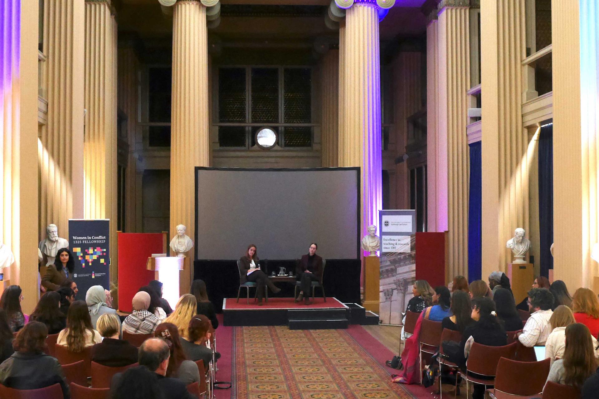 speakers in front of a screen in Playfair Library