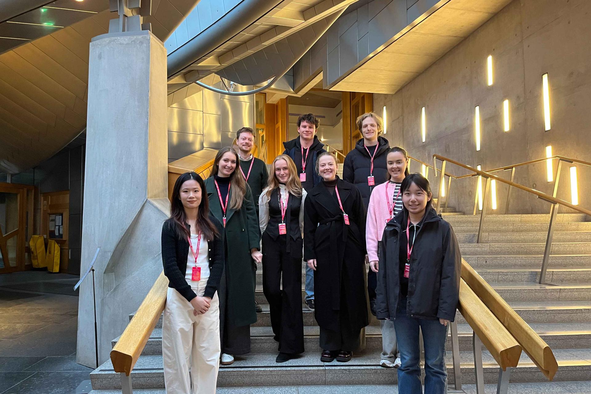 EU law students standing on stairs in the Scottish Parliament building