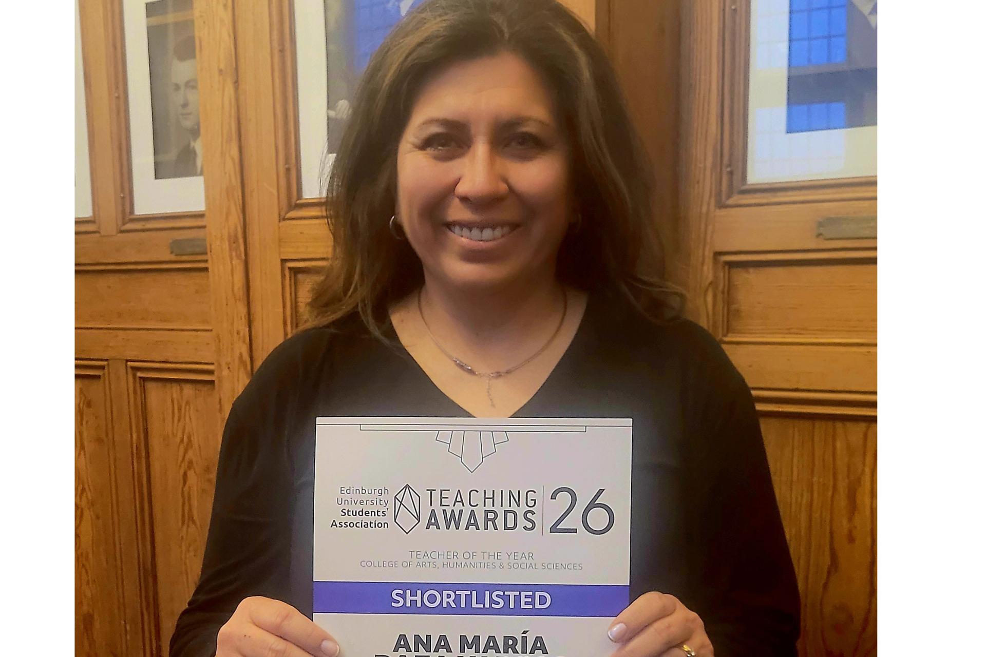 Ana Maria Daza Vargas holding her certificate from the ceremony