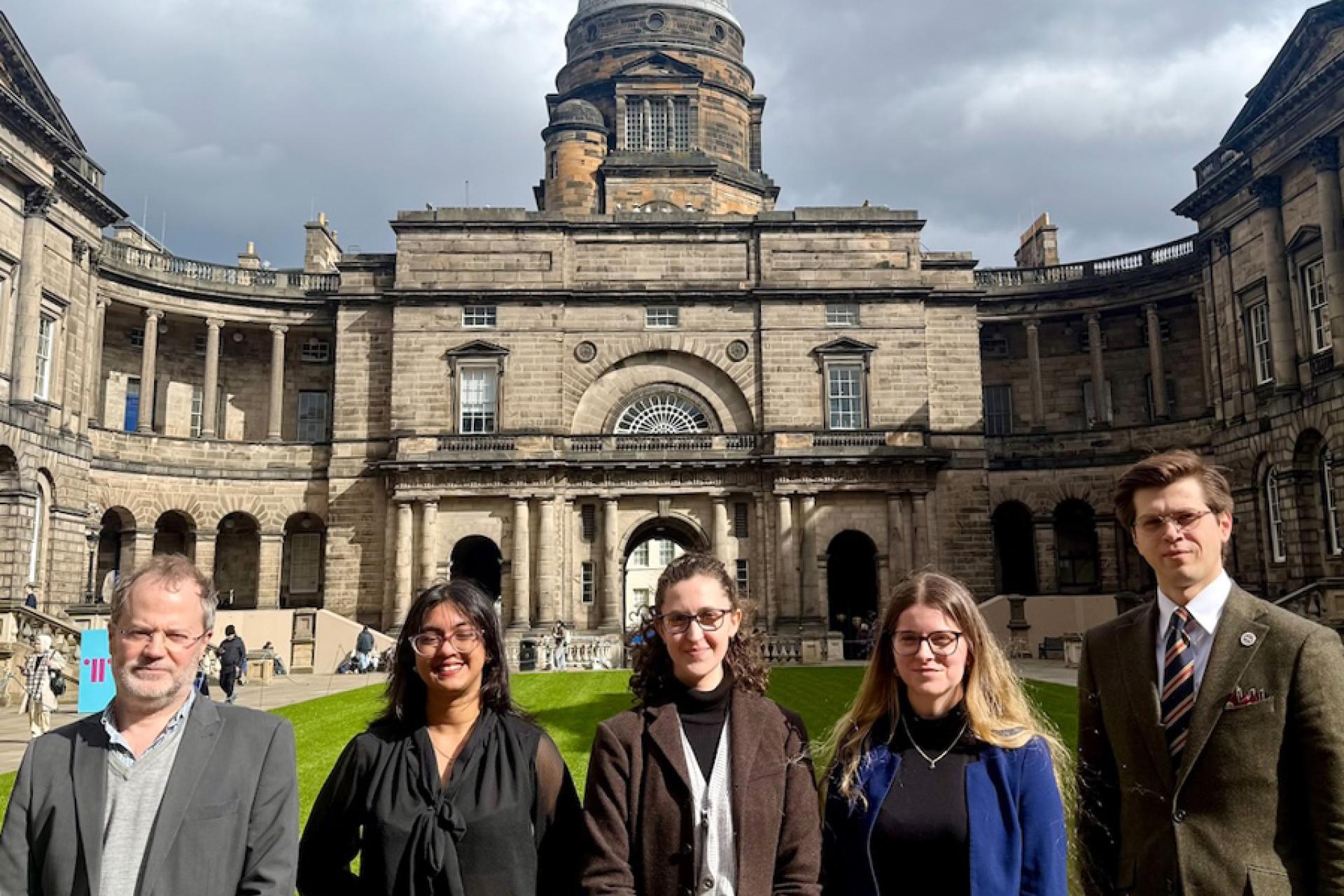 Edinburgh team standing in front of Old College