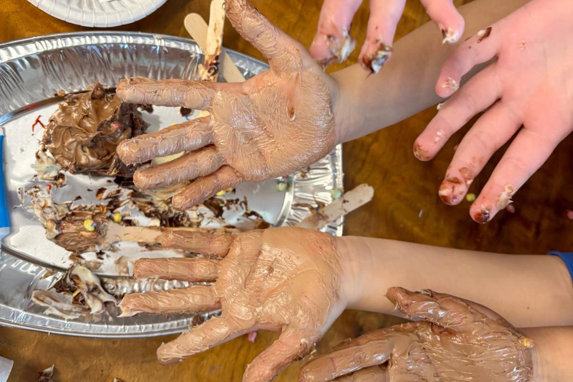 hands covered in chocolate