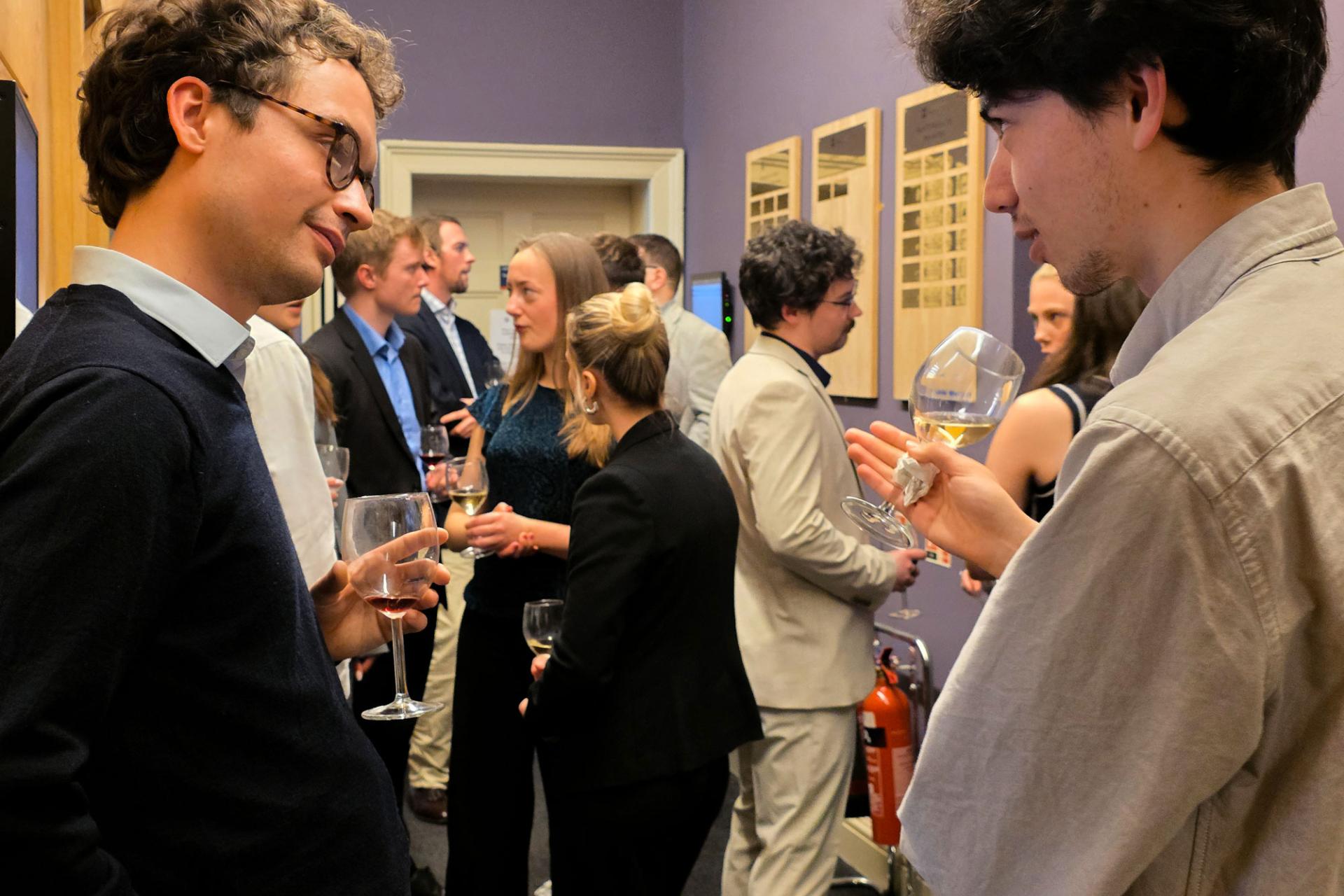 people standing chatting at the mooting celebration event