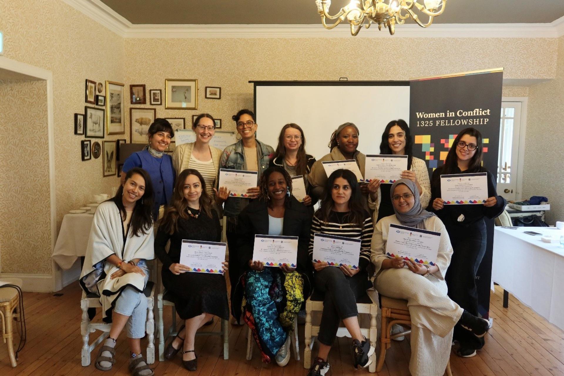 the women in conflict fellowship participants sitting in a group smiling