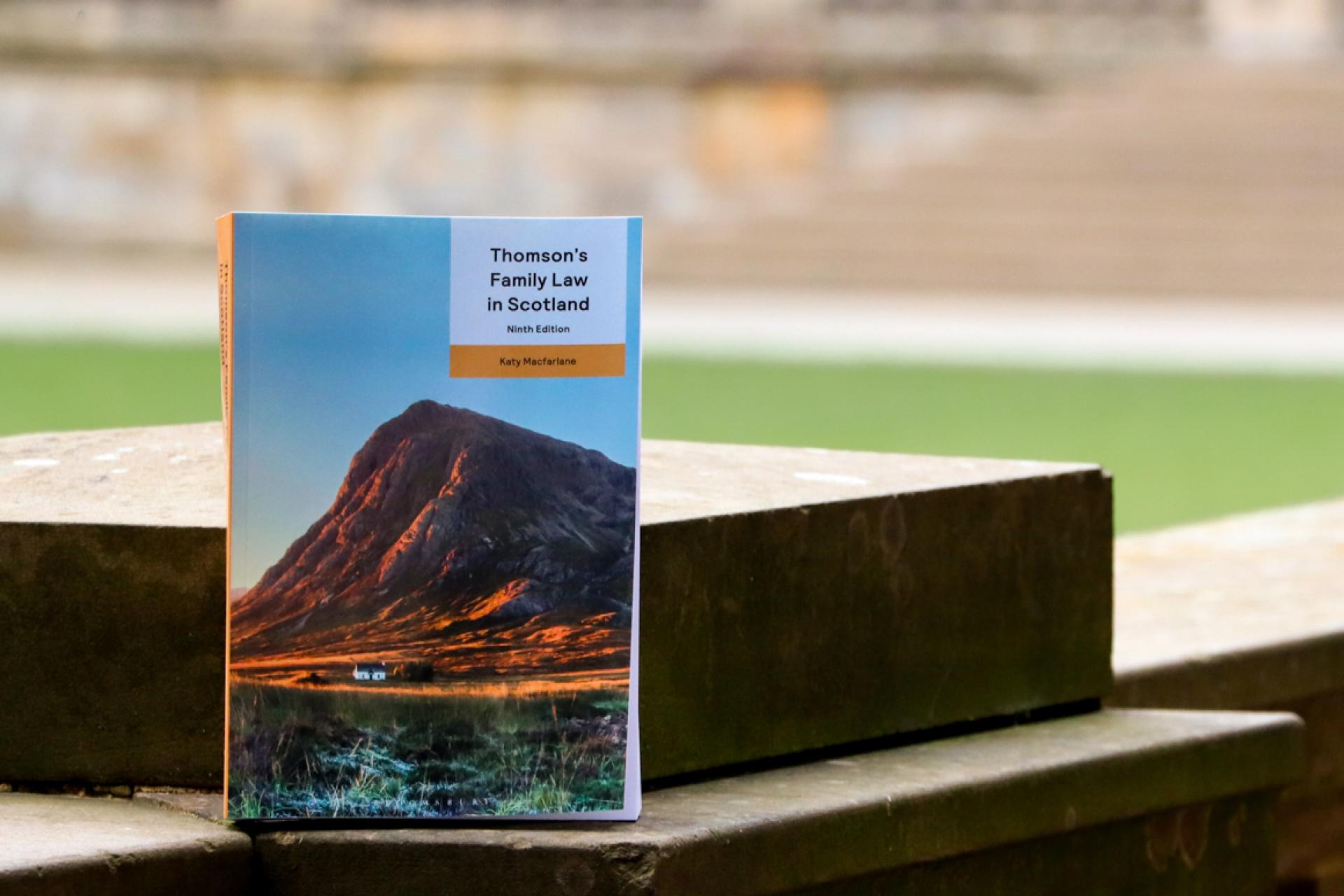 Katy Macfarlane's book with Old College Quad in the background