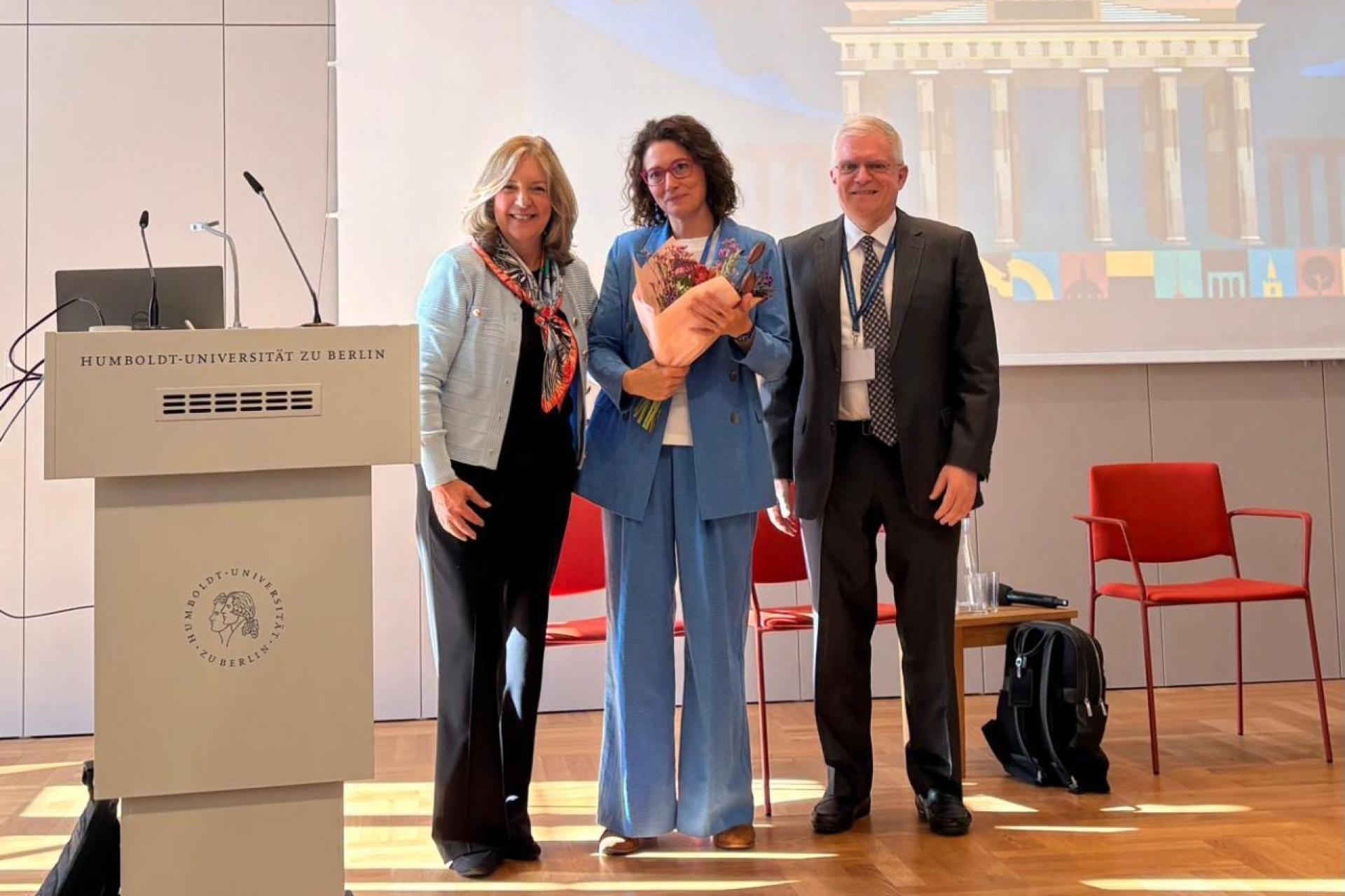 Alexandra Bruan on stage collecting prize