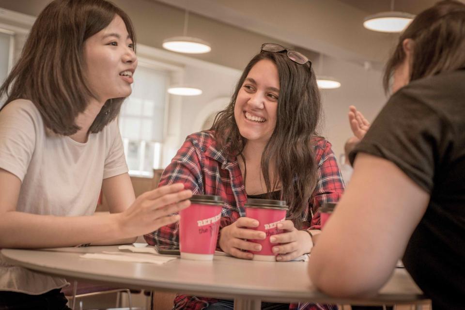 Students on a table drinking coffee